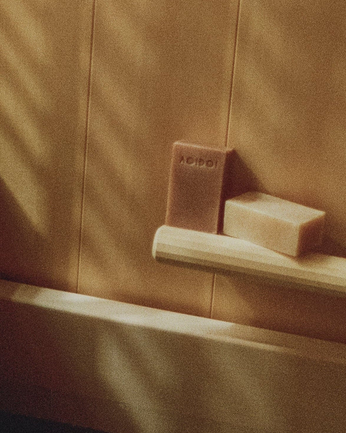 Bathroom corner with a wooden bathtub, aoidoi soap, bathed in warm sunlight in a traditional japanese bath