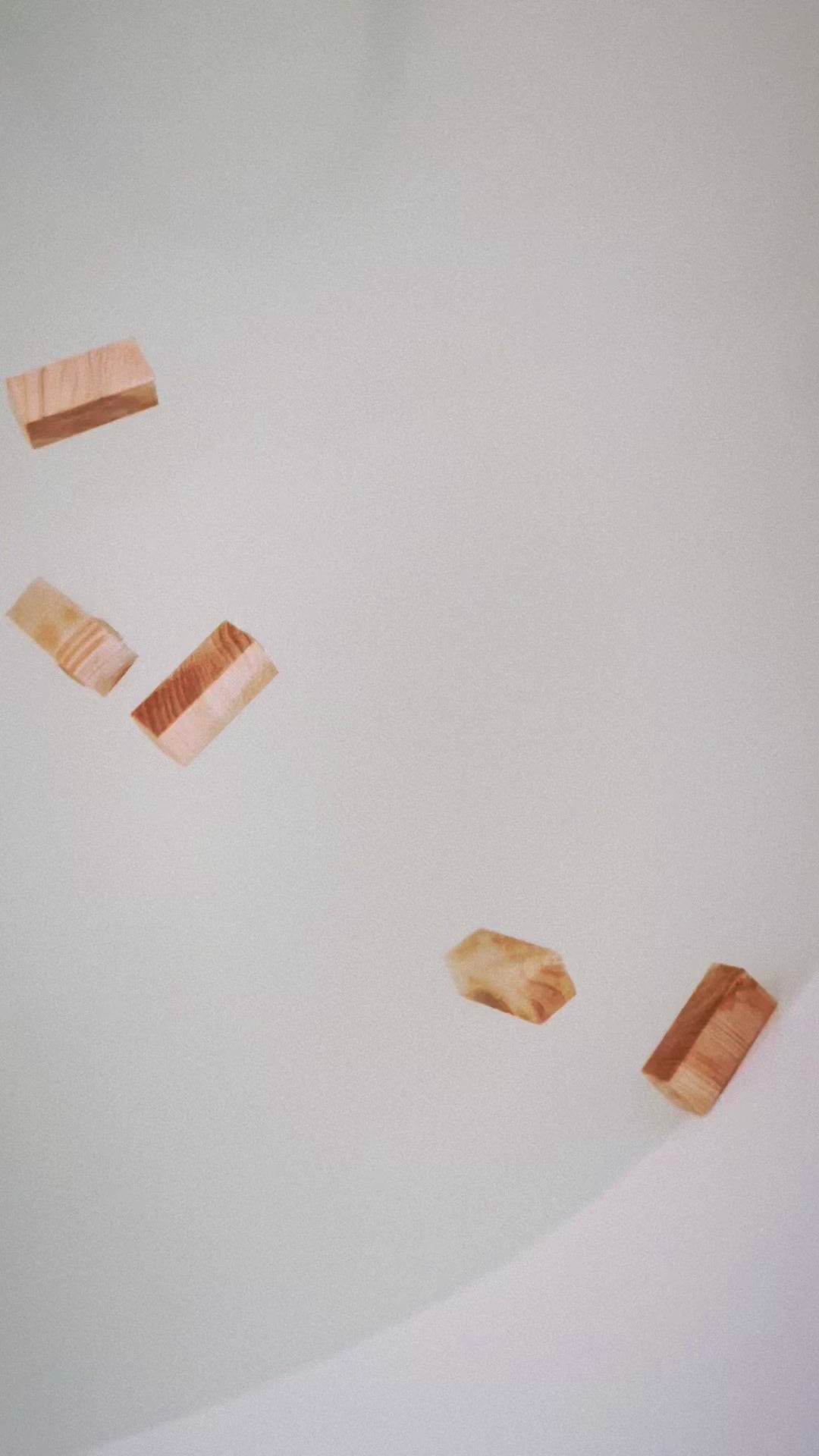 Hinoki blocks releasing a grounding aroma in a warm bath.